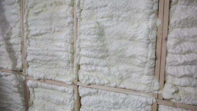 The wooden wall of the house is insulated with special foam for heat and sound insulation, construction