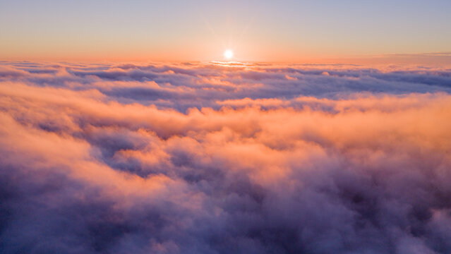 Beautiful Sunset with Purple Tint , Aerial Shot Above Clouds