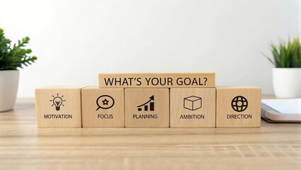 Wooden cubs spelling 'What's Your Goal' on table with supportive words and symbols