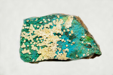 Chrysocolla with turquoise calcite on a light background. Gems, mineralogy, jewelry.