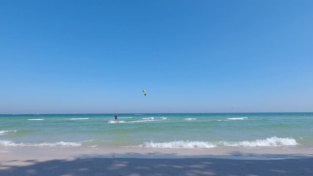 Kiters are having fun in a good wind at the famous Kite Beach,