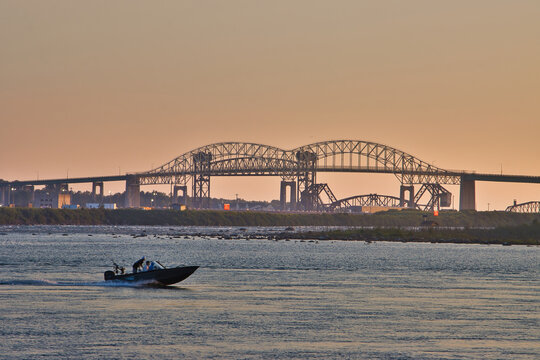 The Sault Ste. Marie International Bridge over St Marys River on the USA/Canada border at sunset