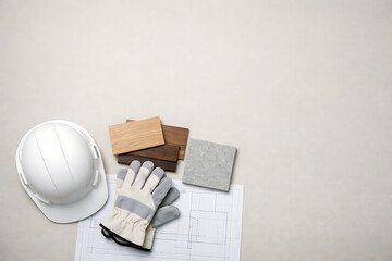 Construction materials and safety gear on blueprint