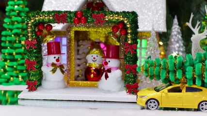 A car drives up to a house past many Christmas trees