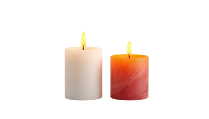 Two lit candles in different colors on a