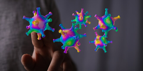 Artistic depiction of coronavirus cells floating near a hand. Conceptual image of the global pandemic and the