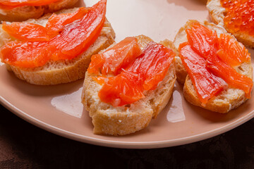 Close-up of canap s with red caviar and trout on a plate