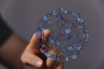 Hand touching a digital network with letters, symbolizing technology, communication, and information access in