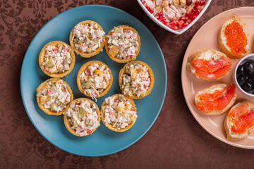 Chicken salad. Salad in tartlets. Canapes with red caviar, trout