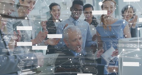 Clapping team around seated senior in business casual at desk, pointing at monitor, report, overlay