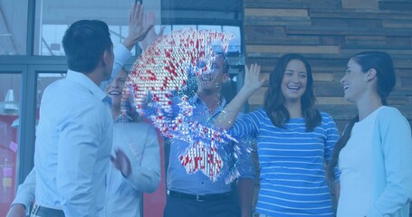 High-fiving five coworkers in modern office, wearing white and blue shirts, with holographic globe