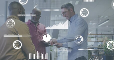 Analyzing three business-casual coworkers reviewing laptop and tablet in office, with HUD charts