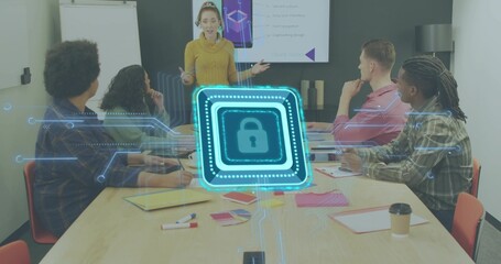 Presenting woman in mustard sweater gesturing at table in meeting room, with holographic padlock