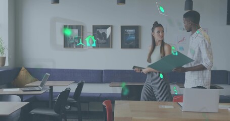 Reviewing male coworker and junior colleague holding green folder in coworking area, copy space