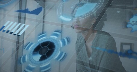 Analyzing mid adult woman studying AR data at modern office, wearing grey blazer and glasses