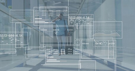 Walking man in blue shirt with bag-strap, phoning, passing glass door in office with data overlay