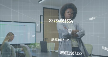 Standing woman in gray blazer crossing arms and watching meeting room laptop with numeric overlay