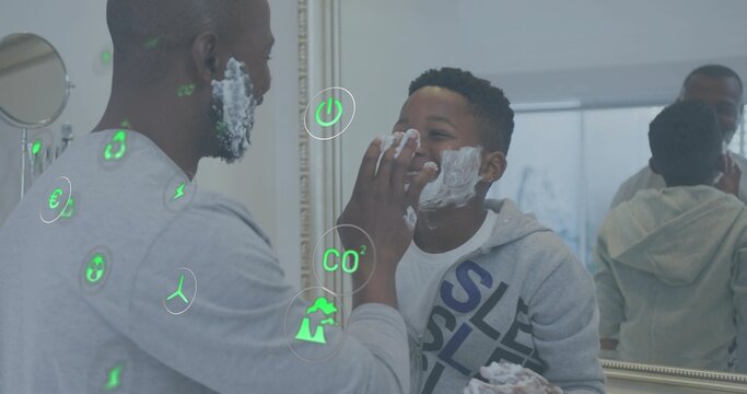 Applying shaving foam father and son wearing grey tops at home bathroom sink, with mirror holograms