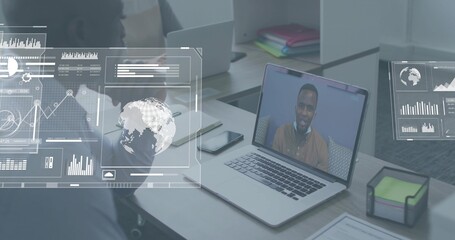 Viewing colleague on laptop wearing tan shirt at desk, man in dark shirt listening, phone, HUD