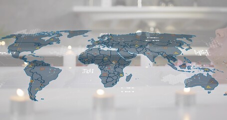 Displaying translucent world map overlay covering most of frame on glass desk, with warning icons