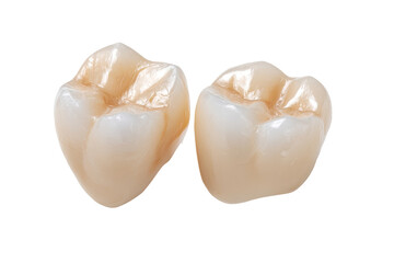 Two dental crowns, light beige color,  showing enamel and dentin detail, isolated on black background