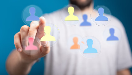 Hand touching digital people icons representing connection, networking, and social interaction....