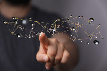 Conceptual image of a digital network with a person's finger pointing at the connection points symbolizing info