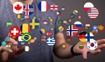 Hand holding floating flags of various countries, symbolizing globalization, international relations, and world unity. Perfect for business, tra