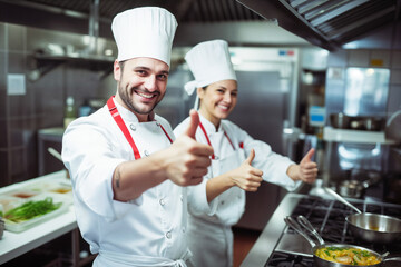 Professional Chefs Giving Thumbs Up in Commercial Kitchen