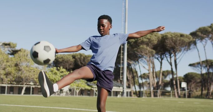 Initial short kicks are starting soccer ball juggling on turf while practicing ball control