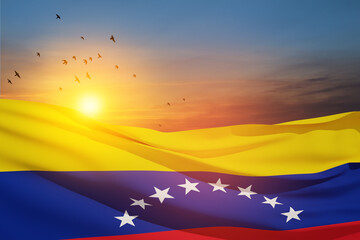 Naklejka premium Venezuela flag on background of sunset sky with flying birds. Patriotic concept. Banner with place for text.
