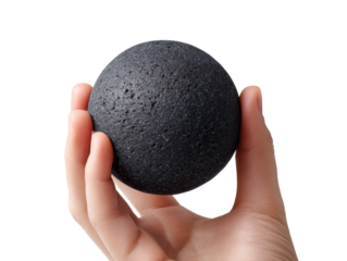 Hand holding a black stress ball stone with firm grip and natural skin texture isolated on transparent background.
