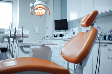 empty dental treatment room with a chair, overhead light, and equipment ready for use.