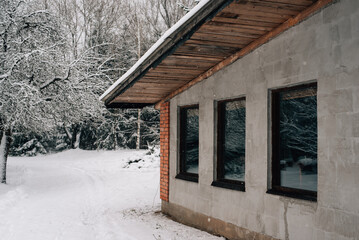 A village house in the middle of a snowy forest