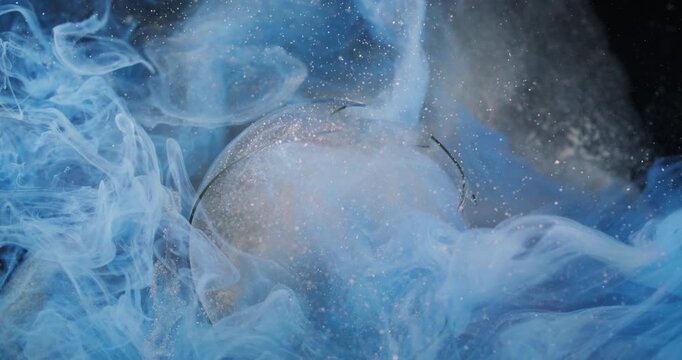 Cloud splash. Glitter blue smoke. Defocused silver color shimmer ink broken glass fog texture on abstract dark black art background.