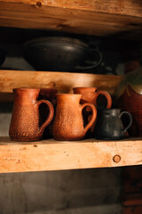 Clay pots and utensils on a shelf