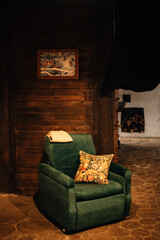 A soft chair with a pillow at the dacha