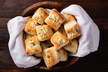 Garlic bread bites in a bowl on a wooden table