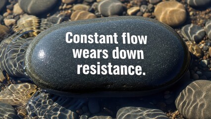 Stone with quote about constant flow and resistance