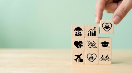 Hand placing a wooden block with various icons representing health education finance and community on a table