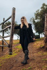 Female Farmer Closing Gate on Rural Farm