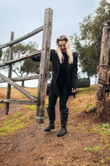 Female Farmer Closing Gate on Rural Farm