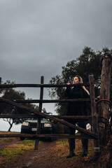 Female Farmer Closing Gate on Rural Farm