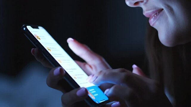Close-up of smartphone use in low light