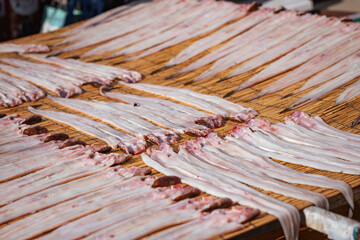 Close up traditional fish fillet sun-dried on a bamboo table, an authentic local food preservation...
