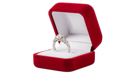 A sparkling diamond ring rests inside a plush red velvet jewelry box, ready for a proposal.