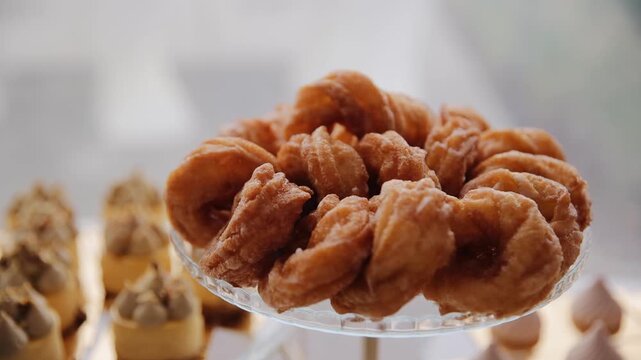 European traditional donuts fried and covered with sweet powder. Sweet candy bar table