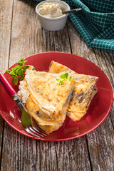 Crepes with ricotta cheese and blackcurrant jam.