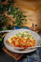 Stuffed pancake baked with cheese.