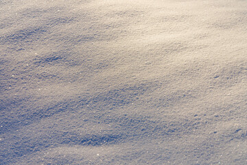 Close-up of fresh sparkling snow texture in bright sunlight